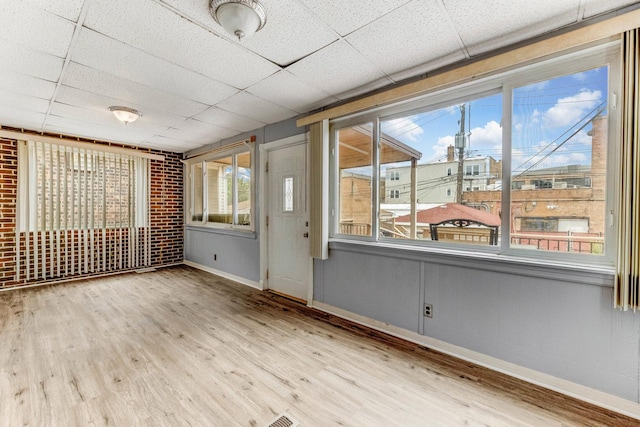 3928 W 63rd Pl, Chicago, IL 60629 - empty room with a paneled ceiling, plenty of natural light, and wood finished floors