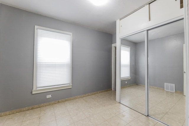 3928 W 63rd Pl, Chicago, IL 60629 - unfurnished bedroom with a closet and light tile patterned floors