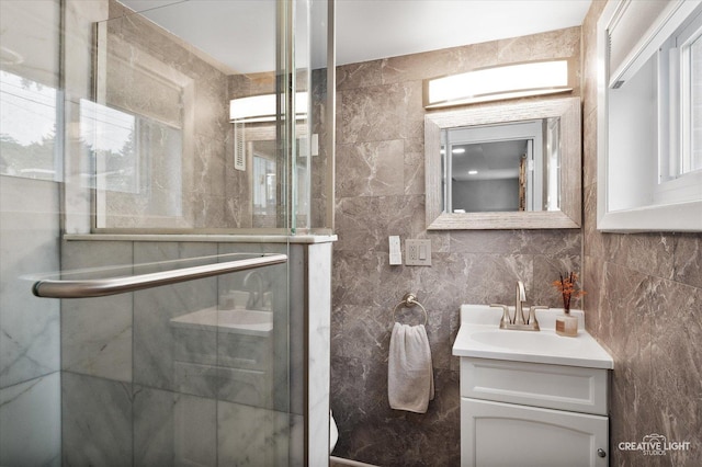 409 N Addison Rd, Villa Park, IL 60181 - bathroom featuring vanity, a stall shower, and tile walls