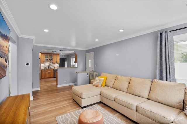 409 N Addison Rd, Villa Park, IL 60181 - living room featuring arched walkways, light wood-style floors, crown molding, and recessed lighting