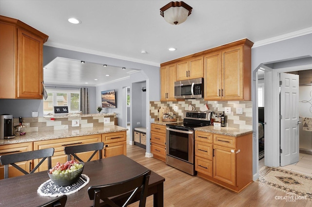 409 N Addison Rd, Villa Park, IL 60181 - kitchen featuring appliances with stainless steel finishes, arched walkways, decorative backsplash, crown molding, and light wood-type flooring