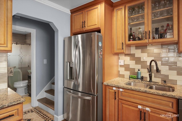 409 N Addison Rd, Villa Park, IL 60181 - kitchen featuring stainless steel refrigerator with ice dispenser, light stone counters, backsplash, ornamental molding, and glass insert cabinets