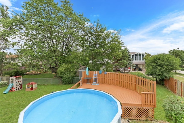 513 White Birch Rd, Lindenhurst, IL 60046 - view of swimming pool featuring a deck, a fenced backyard, and a playground