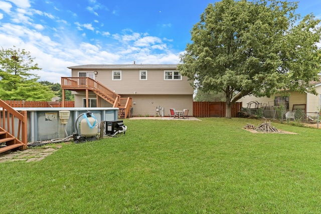 513 White Birch Rd, Lindenhurst, IL 60046 - rear view of house featuring stairs, a fenced backyard, a wooden deck, and an outdoor fire pit
