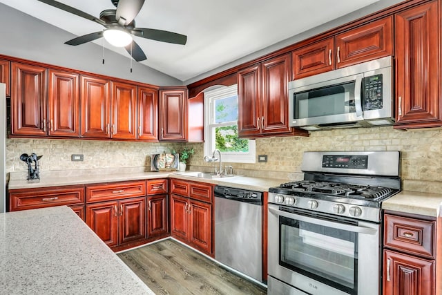 513 White Birch Rd, Lindenhurst, IL 60046 - kitchen featuring appliances with stainless steel finishes, reddish brown cabinets, dark wood-style floors, and lofted ceiling