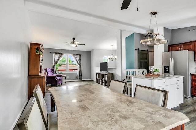 513 White Birch Rd, Lindenhurst, IL 60046 - dining space with ceiling fan, a barn door, dark wood-style flooring, and a chandelier