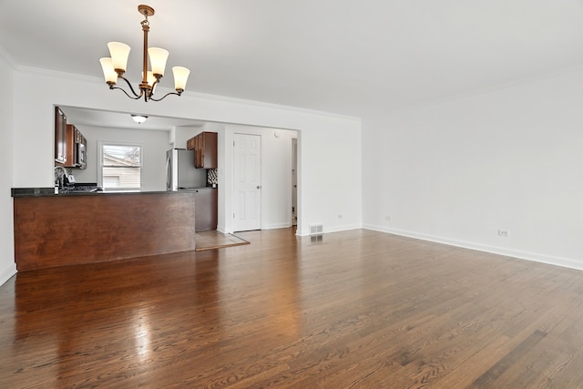 5222 Wright Ter, Skokie, IL 60077 - unfurnished living room with a chandelier, dark wood-style flooring, and ornamental molding