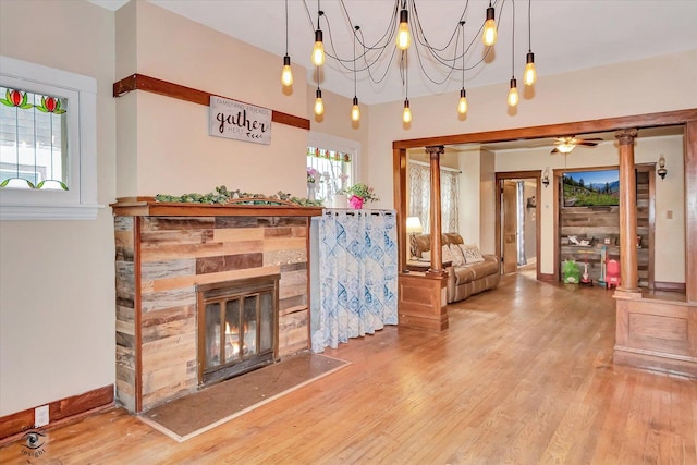 9826 S Walden Pkwy, Chicago, IL 60643 - living room featuring wood finished floors, a fireplace, ceiling fan, and a chandelier