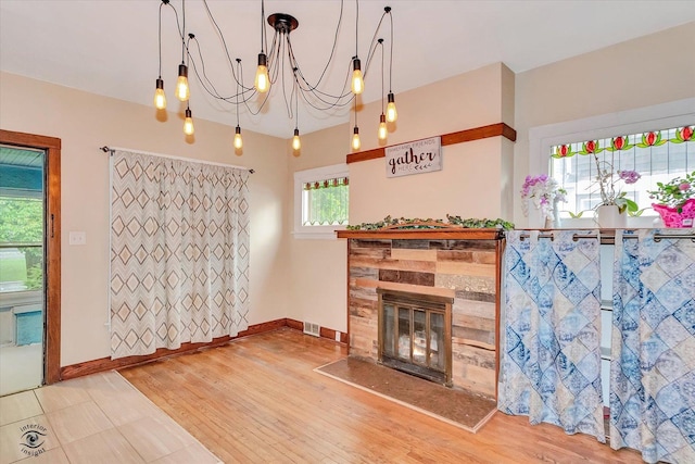9826 S Walden Pkwy, Chicago, IL 60643 - living room featuring a chandelier, wood finished floors, and a fireplace
