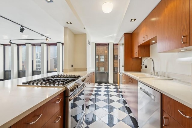 1230 N State Pkwy Unit 17A, Chicago, IL 60610 - kitchen featuring stainless steel appliances, light countertops, and brown cabinetry