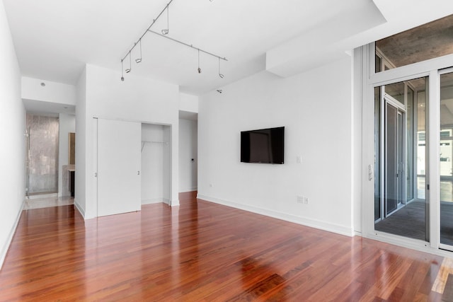 550 N Saint Clair St Unit 2301, Chicago, IL 60611 - unfurnished living room featuring wood finished floors and rail lighting