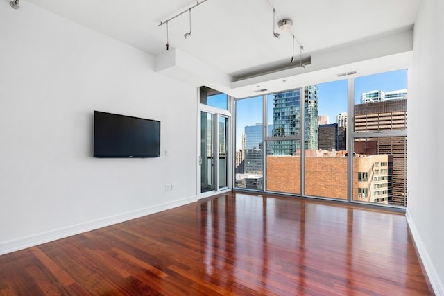 550 N Saint Clair St Unit 2301, Chicago, IL 60611 - unfurnished room featuring wood finished floors, a wall of windows, and track lighting