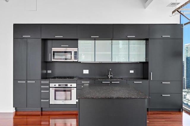 550 N Saint Clair St Unit 2301, Chicago, IL 60611 - kitchen with appliances with stainless steel finishes, dark wood finished floors, modern cabinets, and a kitchen island