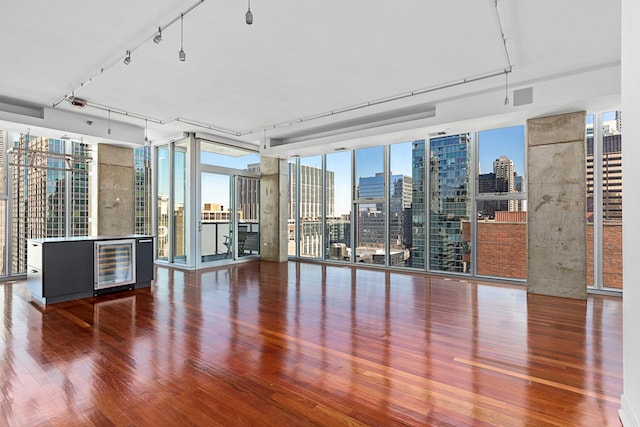 550 N Saint Clair St Unit 2301, Chicago, IL 60611 - unfurnished room with beverage cooler, expansive windows, wood finished floors, and a skyline view