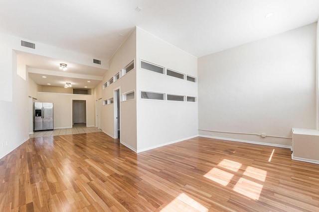 2120 W Grand Ave Unit D, Chicago, IL 60612 - unfurnished living room featuring light wood-style flooring and recessed lighting