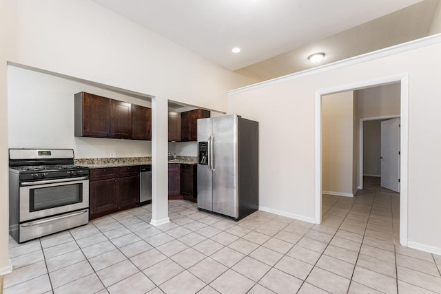 2120 W Grand Ave Unit D, Chicago, IL 60612 - kitchen featuring stainless steel appliances, dark brown cabinetry, light tile patterned floors, light stone countertops, and recessed lighting