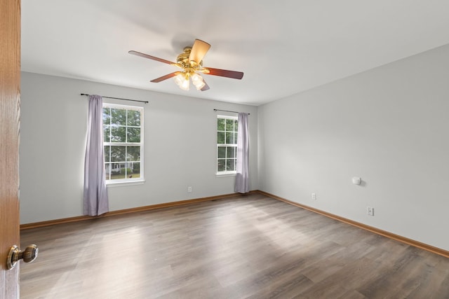 14208 S Napa Cir, Plainfield, IL 60544 - unfurnished room with plenty of natural light, a ceiling fan, and wood finished floors