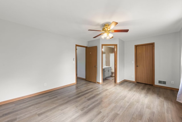 14208 S Napa Cir, Plainfield, IL 60544 - unfurnished bedroom featuring light wood-style flooring, ensuite bathroom, and a ceiling fan