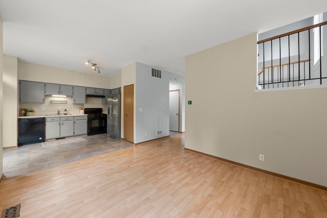 14208 S Napa Cir, Plainfield, IL 60544 - unfurnished living room featuring light wood-style flooring and baseboards