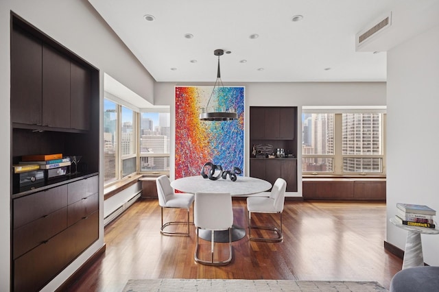 800 N Michigan Ave Unit 2502, Chicago, IL 60611 - dining room featuring wood finished floors, a baseboard radiator, a view of city, and recessed lighting