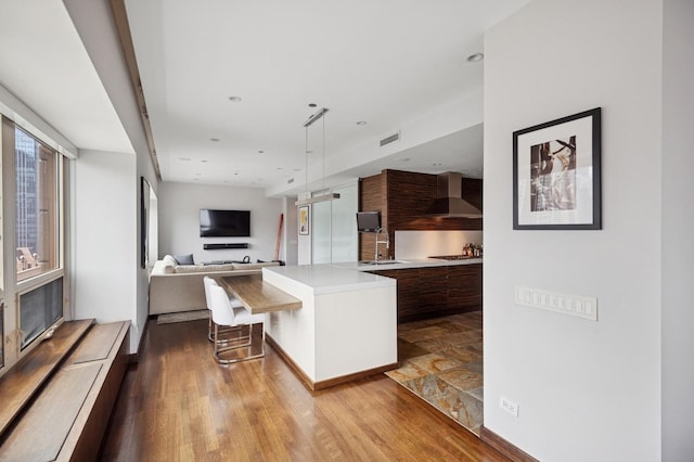 800 N Michigan Ave Unit 2502, Chicago, IL 60611 - kitchen with modern cabinets, light countertops, wall chimney exhaust hood, a kitchen breakfast bar, and open floor plan