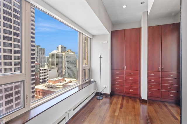 800 N Michigan Ave Unit 2502, Chicago, IL 60611 - bedroom featuring dark wood-style flooring, a baseboard heating unit, a view of city, and recessed lighting