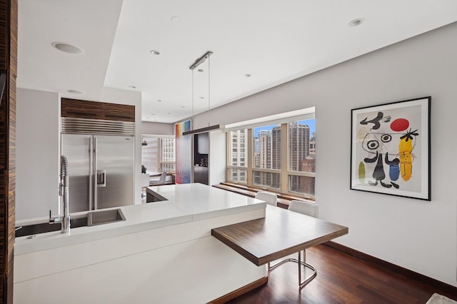 800 N Michigan Ave Unit 2502, Chicago, IL 60611 - kitchen featuring dark wood-style floors, built in fridge, hanging light fixtures, light countertops, and recessed lighting