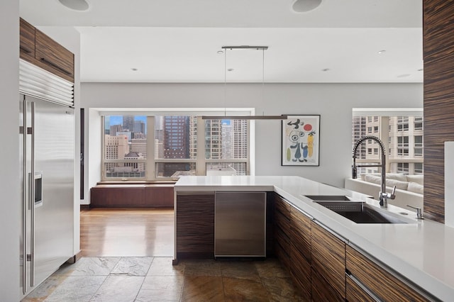 800 N Michigan Ave Unit 2502, Chicago, IL 60611 - kitchen with stainless steel built in refrigerator, light countertops, modern cabinets, and decorative light fixtures
