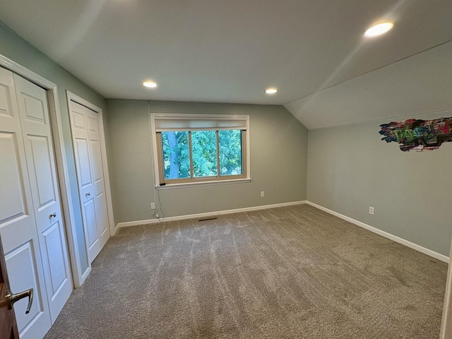 214 Tiverton Rd, Kankakee, IL 60901 - unfurnished bedroom featuring multiple closets, carpet flooring, lofted ceiling, and recessed lighting