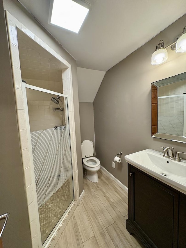 214 Tiverton Rd, Kankakee, IL 60901 - bathroom featuring vanity, a shower stall, vaulted ceiling, and wood finished floors