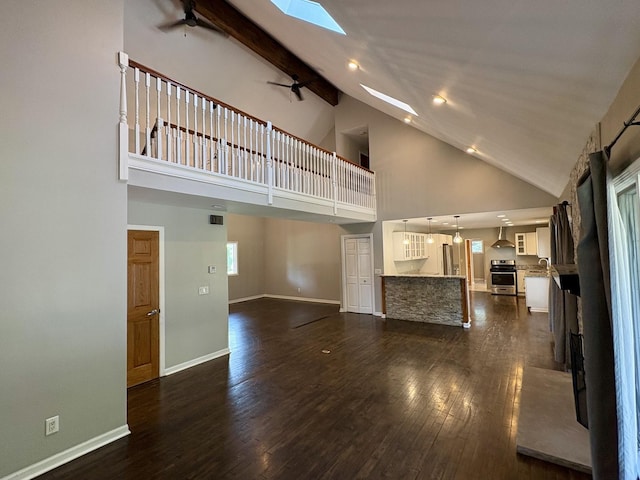 214 Tiverton Rd, Kankakee, IL 60901 - unfurnished living room featuring a skylight, ceiling fan, high vaulted ceiling, dark wood-style floors, and recessed lighting
