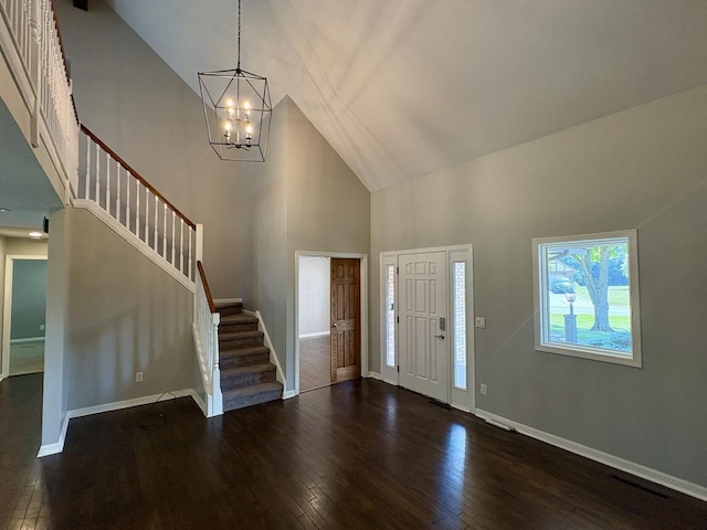 214 Tiverton Rd, Kankakee, IL 60901 - entryway with high vaulted ceiling, stairs, a chandelier, and dark wood-style floors