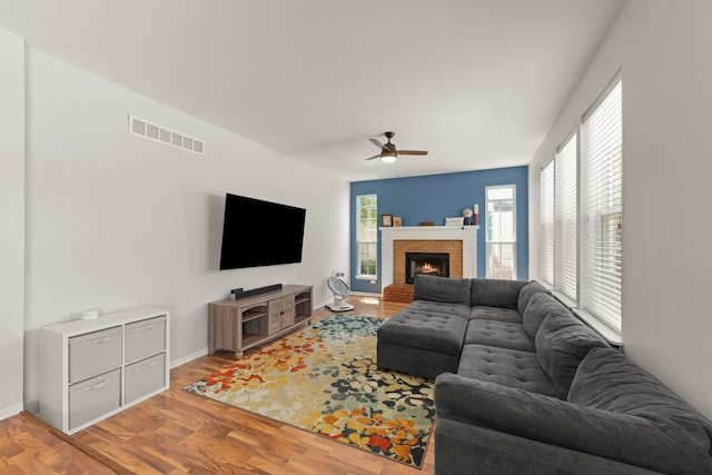 7425 Rosewind Dr, Plainfield, IL 60586 - living room with a ceiling fan, light wood-style flooring, and a brick fireplace