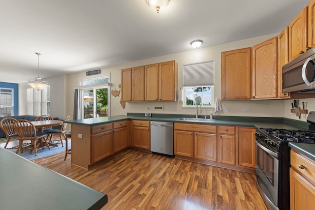 7425 Rosewind Dr, Plainfield, IL 60586 - kitchen featuring stainless steel appliances, a peninsula, plenty of natural light, and dark countertops