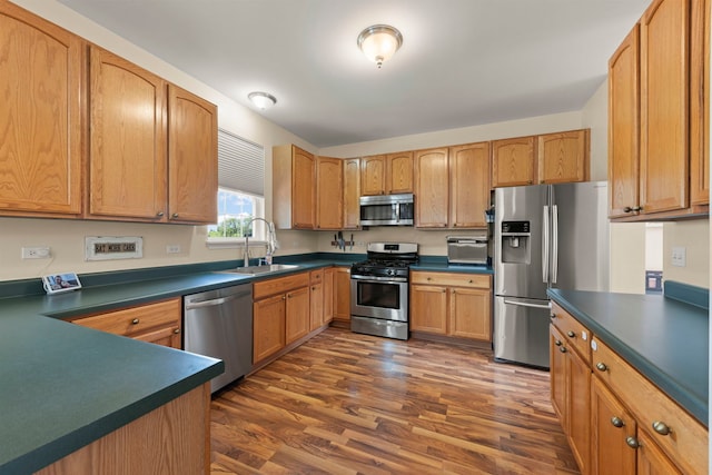 7425 Rosewind Dr, Plainfield, IL 60586 - kitchen with appliances with stainless steel finishes, dark countertops, and dark wood finished floors