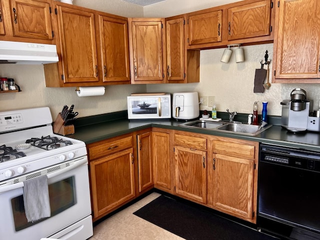 3111/2 W Graham St, Dixon, IL 61021 - kitchen with white appliances, under cabinet range hood, brown cabinetry, and dark countertops