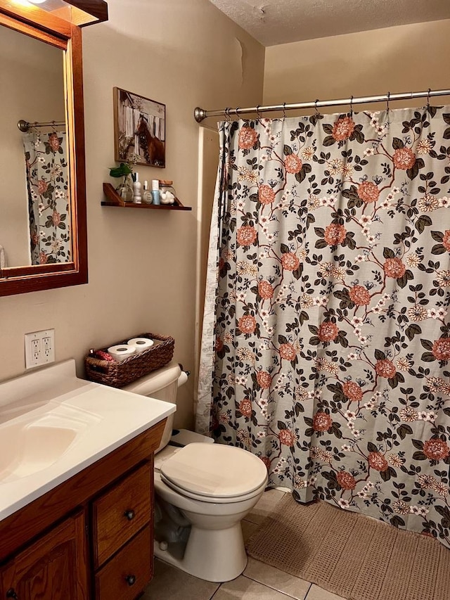 3111/2 W Graham St, Dixon, IL 61021 - bathroom with vanity, tile patterned floors, a shower with curtain, and a textured ceiling
