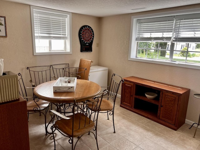 3111/2 W Graham St, Dixon, IL 61021 - dining area featuring a textured wall, a textured ceiling, and light tile patterned flooring