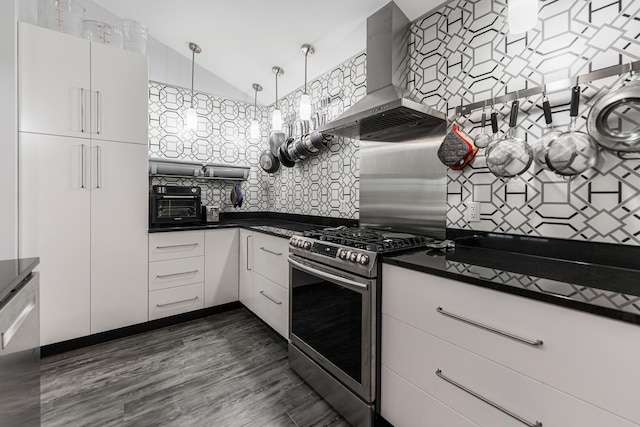 2182 Waterbury Ln E Unit 2182, Sycamore, IL 60178 - kitchen with stainless steel gas stove, wall chimney range hood, dark countertops, decorative backsplash, and vaulted ceiling