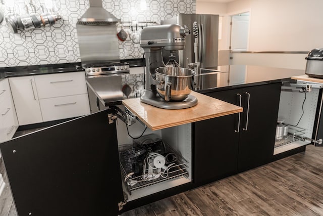 2182 Waterbury Ln E Unit 2182, Sycamore, IL 60178 - kitchen featuring appliances with stainless steel finishes, extractor fan, white cabinetry, decorative backsplash, and dark wood-type flooring