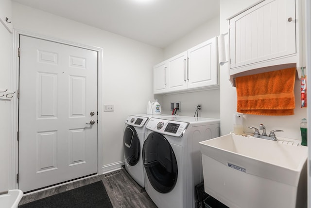 2182 Waterbury Ln E Unit 2182, Sycamore, IL 60178 - laundry room with washer and clothes dryer, dark wood-type flooring, and cabinet space