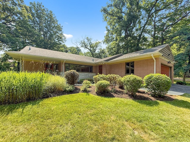 2615 E Chickadee Trl, Rockford, IL 61107 - ranch-style house with a garage, a front yard, and brick siding