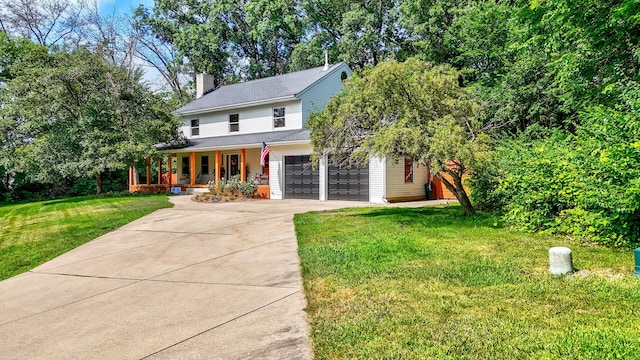 2519 Cherie Ln, Ottawa, IL 61350 - view of front facade with covered porch, driveway, a chimney, a front yard, and an attached garage