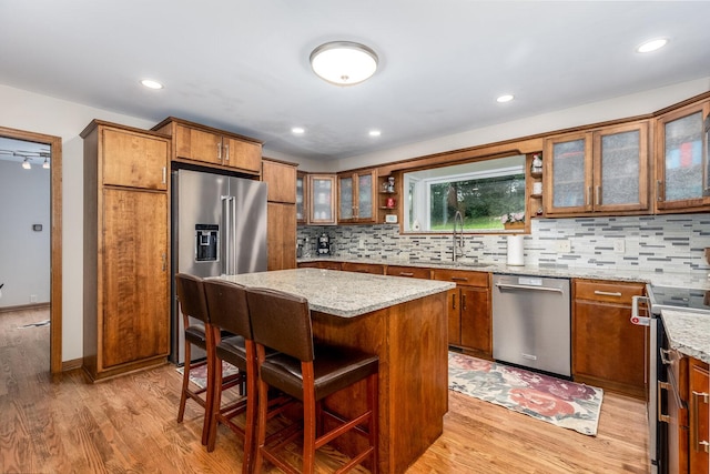 2519 Cherie Ln, Ottawa, IL 61350 - kitchen with appliances with stainless steel finishes, light wood-style floors, brown cabinetry, and recessed lighting
