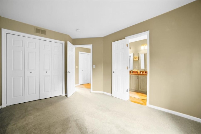 157 Concord Dr, Oswego, IL 60543 - unfurnished bedroom featuring light carpet, a closet, and connected bathroom