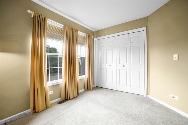 157 Concord Dr, Oswego, IL 60543 - unfurnished bedroom with light carpet and a closet