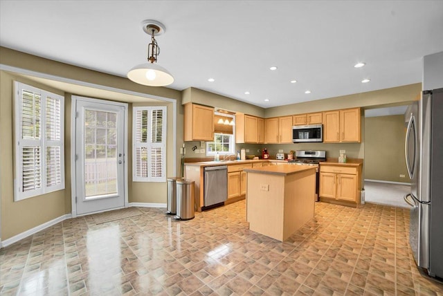 157 Concord Dr, Oswego, IL 60543 - kitchen with appliances with stainless steel finishes, light brown cabinets, a center island, light countertops, and recessed lighting