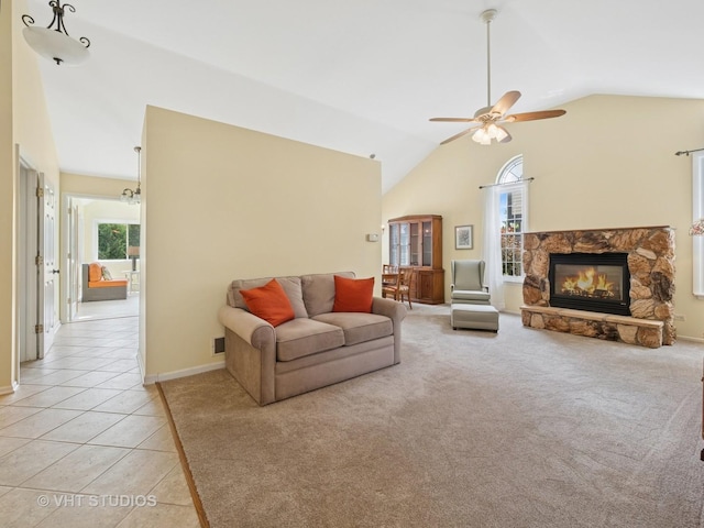 1135 Lexington Ln, Lake Zurich, IL 60047 - living area featuring lofted ceiling, ceiling fan, light tile patterned floors, a stone fireplace, and light carpet