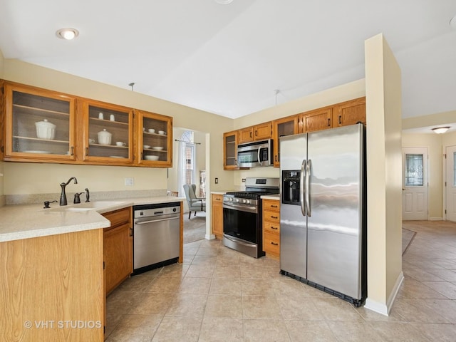 1135 Lexington Ln, Lake Zurich, IL 60047 - kitchen featuring stainless steel appliances, glass insert cabinets, brown cabinets, light countertops, and light tile patterned flooring