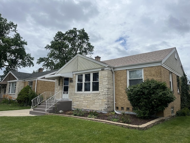 2256 S 15th Ave, North Riverside, IL 60546 - view of front facade with a front yard, a chimney, stone siding, and roof with shingles